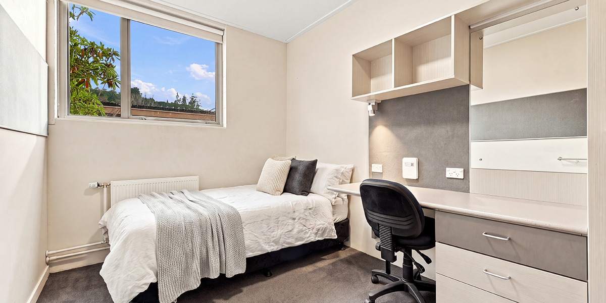Student bedroom with bed and desk 