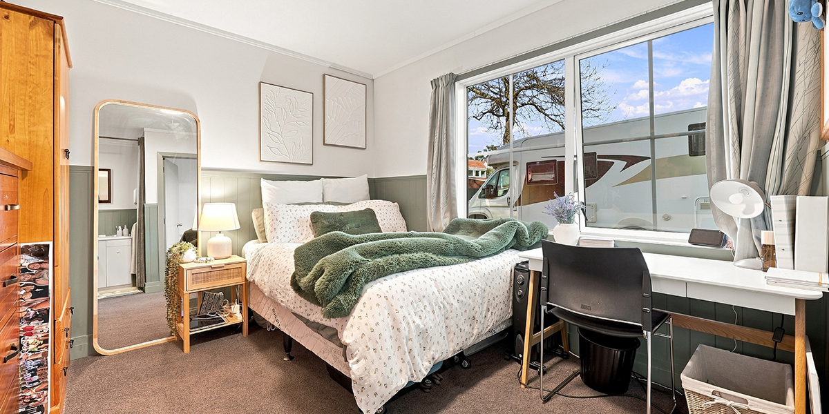 Studet bedroom with desk and large window
