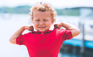 Young child flexing muscles thumbnail