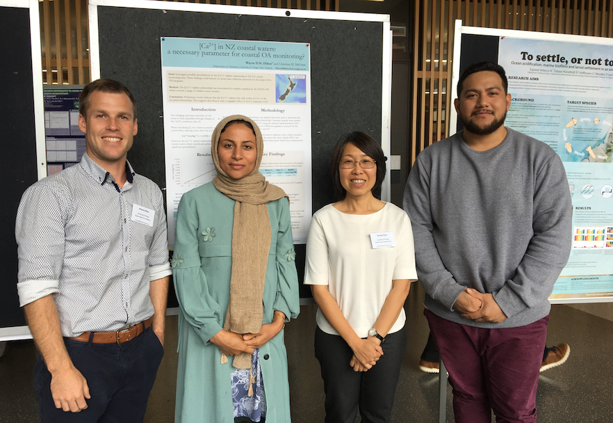 4 Postgraduates in front of their research poster image