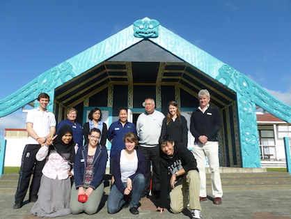 A group of people gathered in front of Noho Marae.