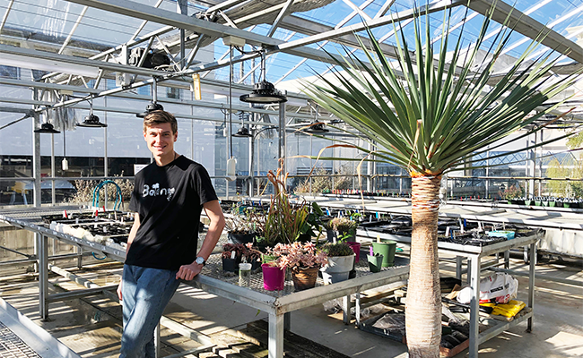 Taylor Davies-Colley in greenhouse with plants image