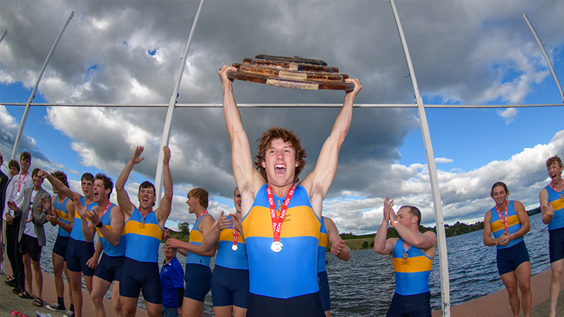 The Otago men’s first eight celebrates winning the Hebberley Shield, held aloft by Oscar  Clatworthy, at Lake Karāpiro at Easter. Photo: @artofrowing.nz 