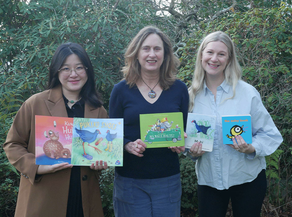 three women holding books