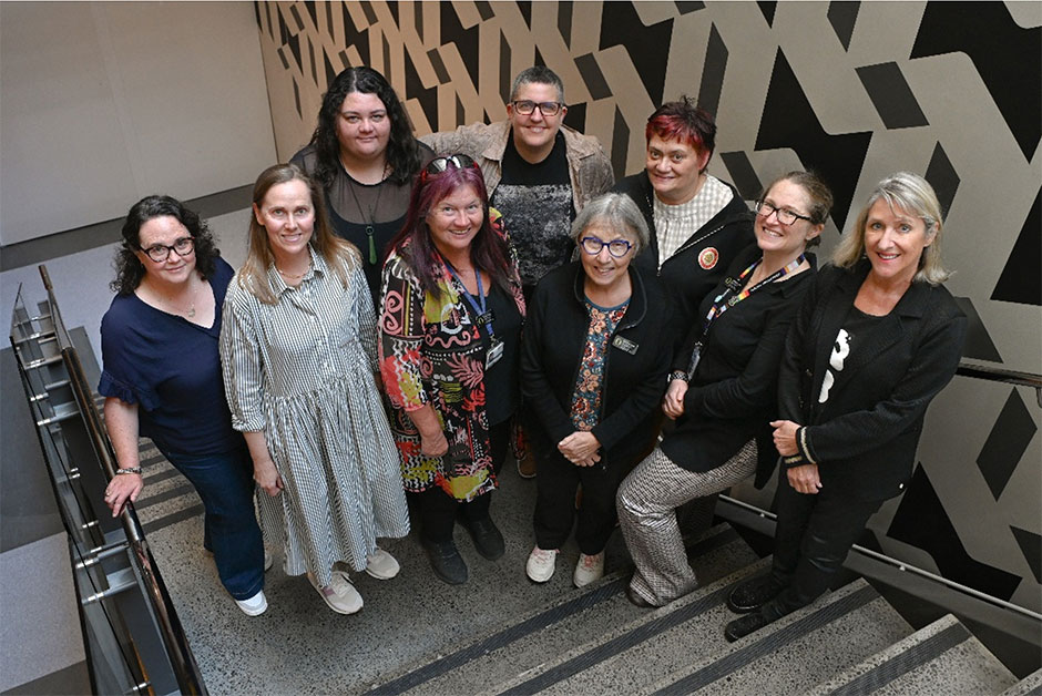 Eight members of the SISE Team standing on steps