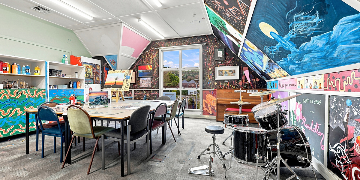 Creative space with art table, drum kit and piano
