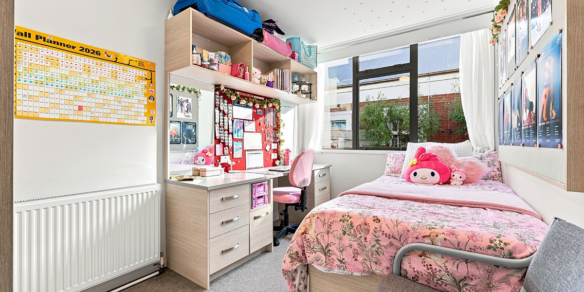 Student bedroom with desk and large window