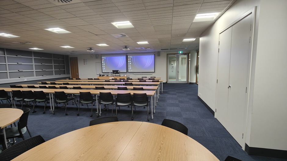 View of Otago Business School room G17, showing tables and chairs in rows and groups