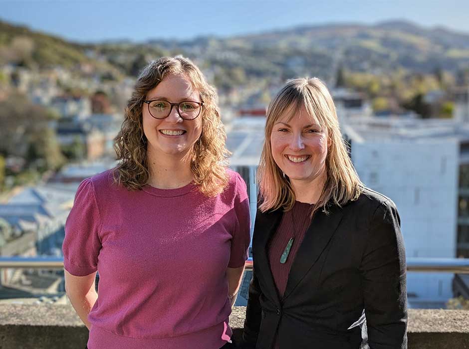 Two women standing on a balcony 