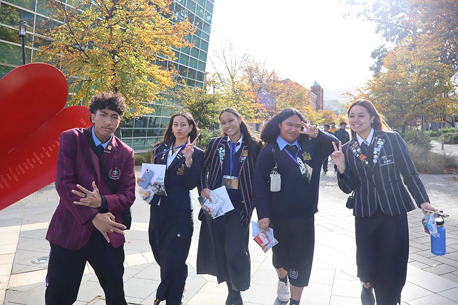 A small group of Pacific Island students in school uniforms posing on the University of Otago campus