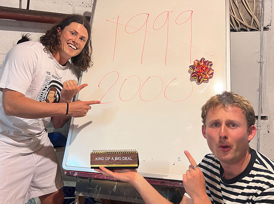 Two men either side of a white board