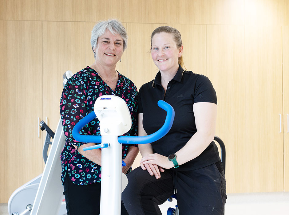 Two women are pictured with exercise equipment.