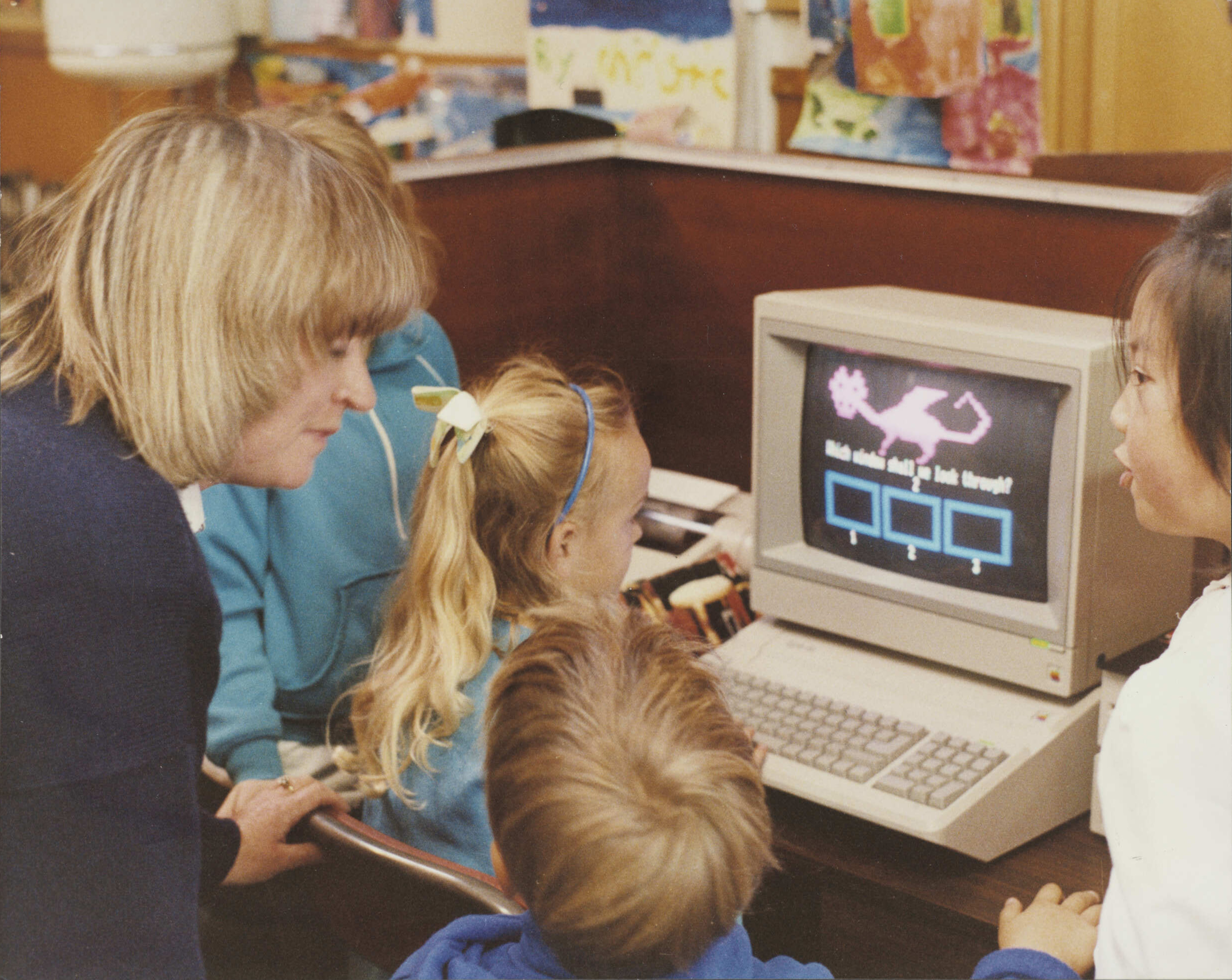 Teacher and children with computer (1990s). 