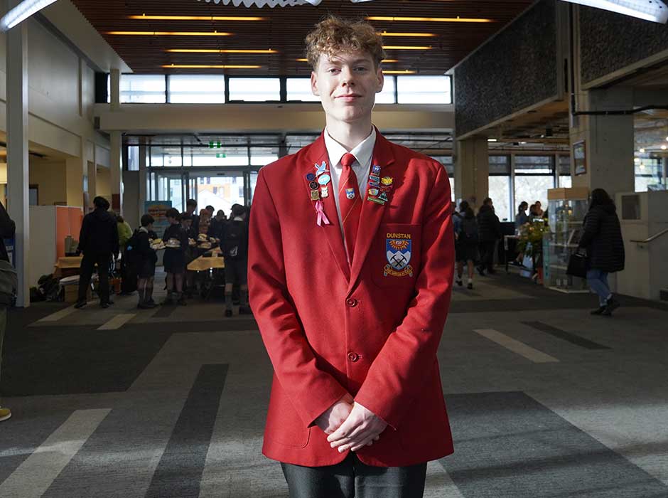 A young man cropped from his waist up
