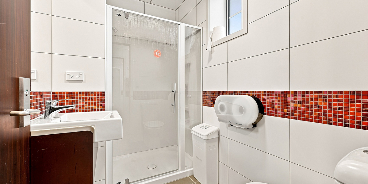Bathroom with toilet, sink and shower