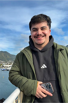 A man is pictured with water in the background.
