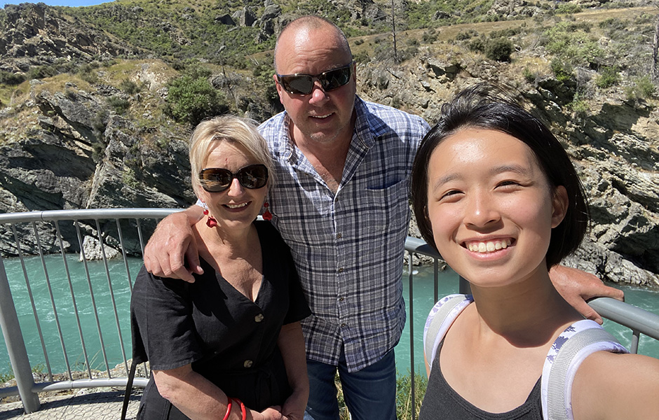Three people taking a self with a bright blue river in the background