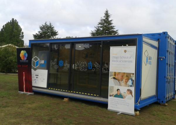 A photo of a lab in a shipping container, set up and ready for students