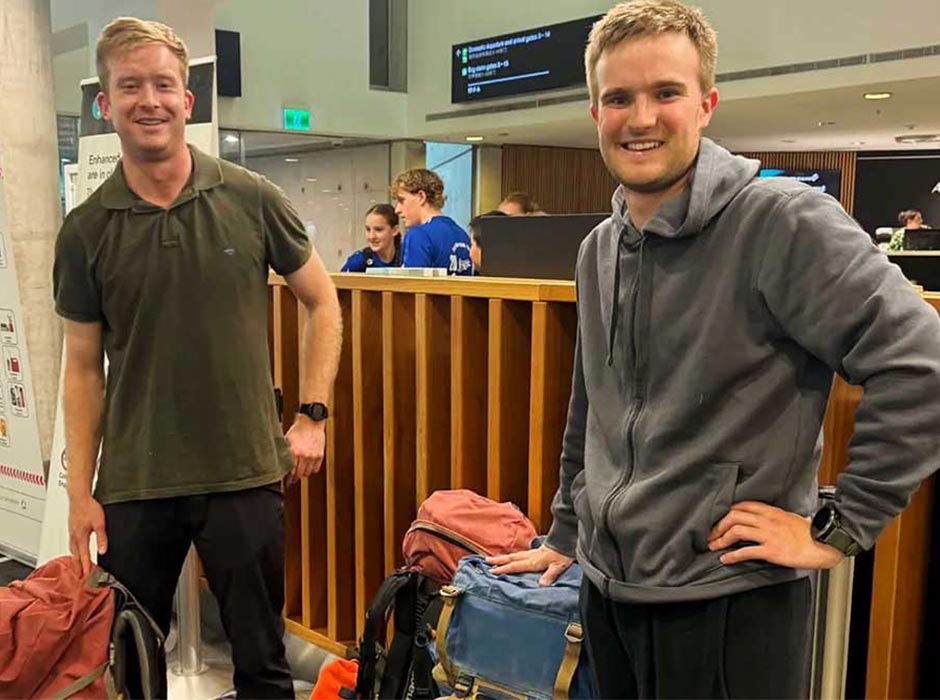 Two men at the airport with their baggage