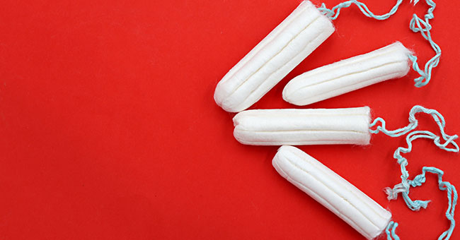 File photo of three tampons on red background