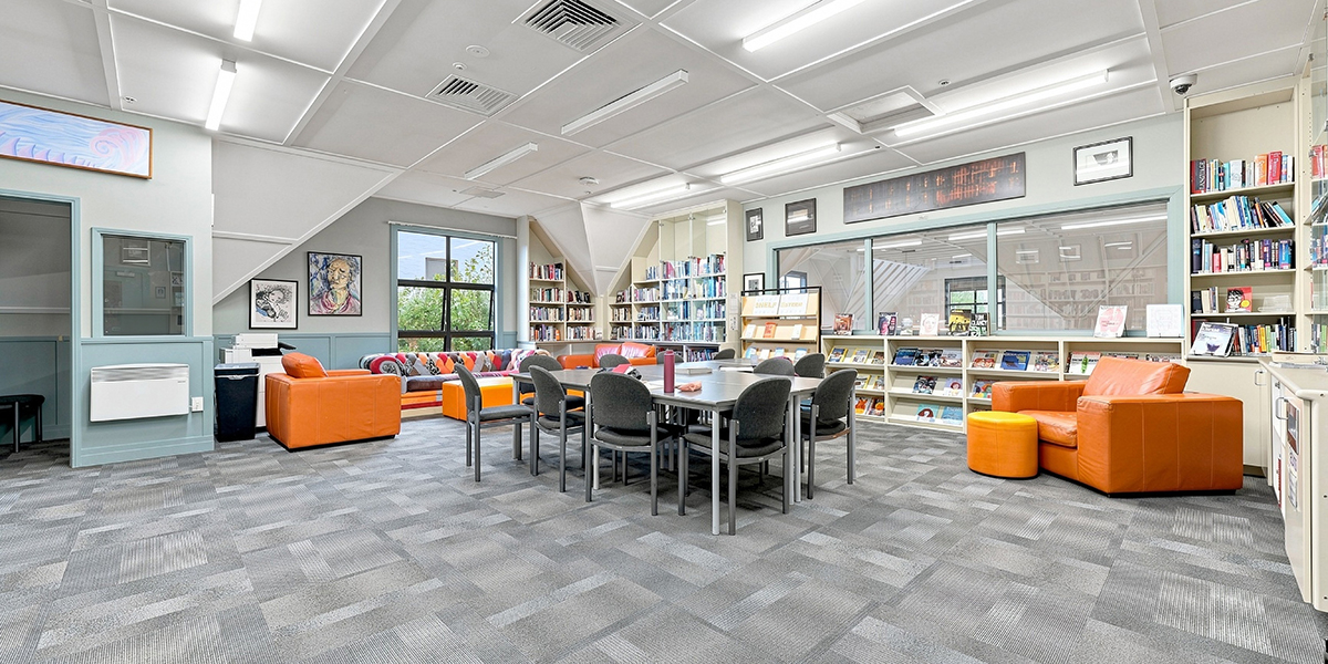 Study area with tables, couches and book shelves