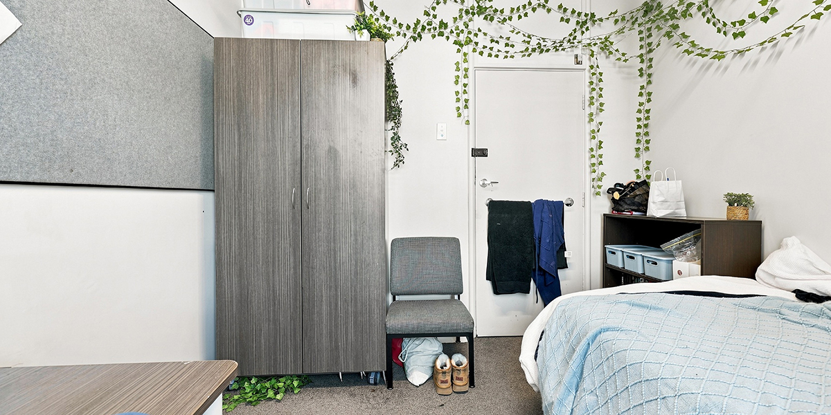 Student bedroom with wardrobe and storage shelves
