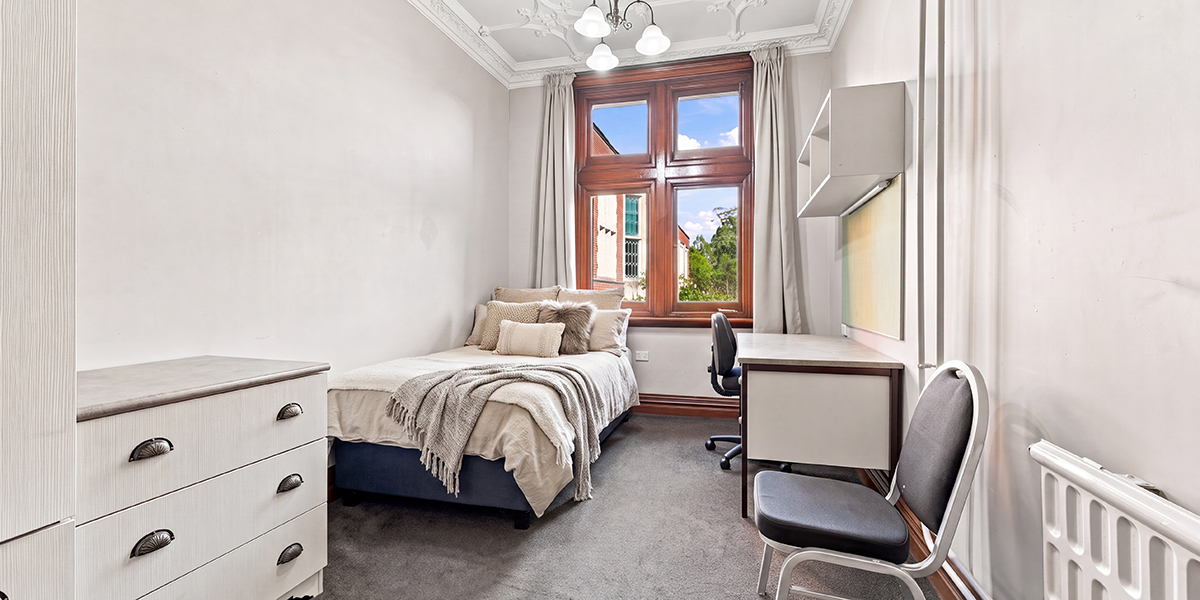 Student bedroom with desk and storage cabinet