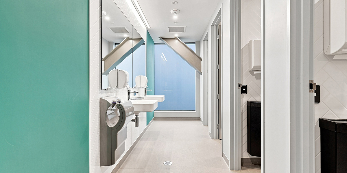 Shared bathroom facilities with side-by-side cubicles