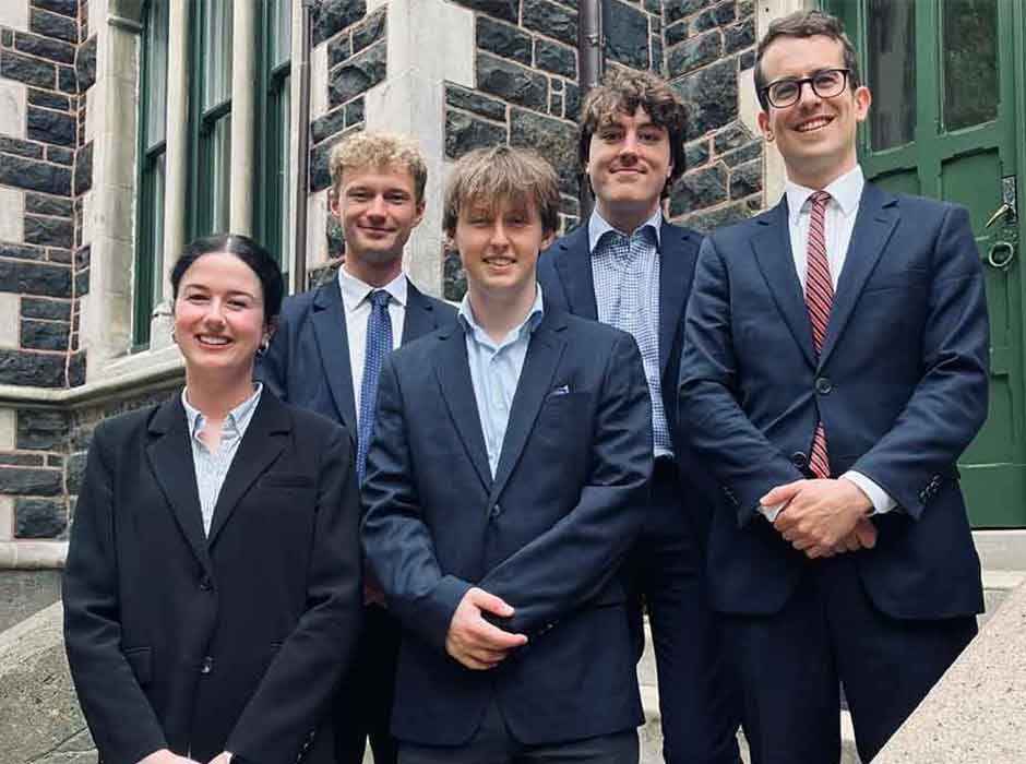 five people standing nex to each other on stairs 