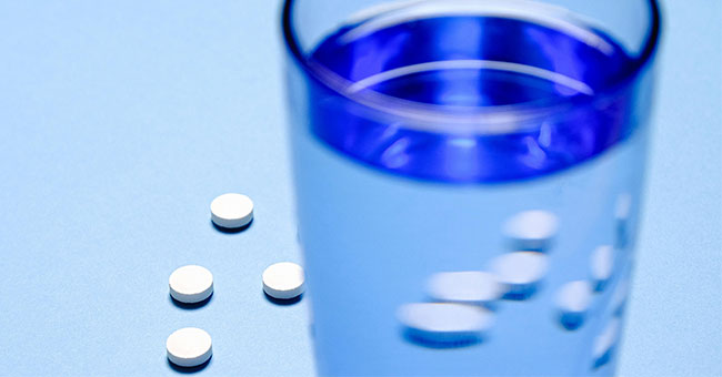 Pills and water generic image