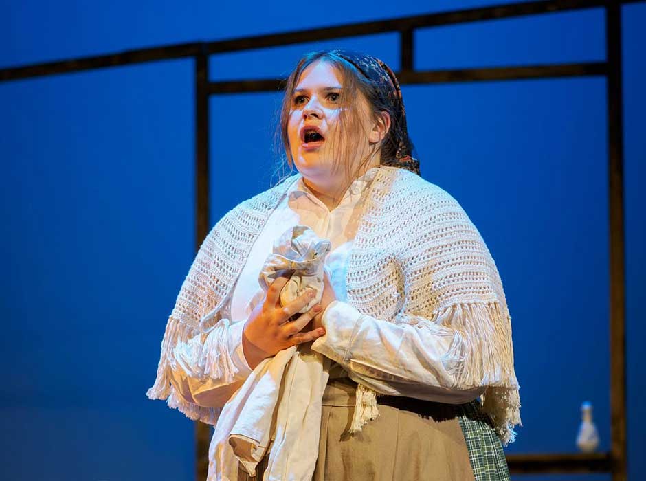 A woman in costume performing 