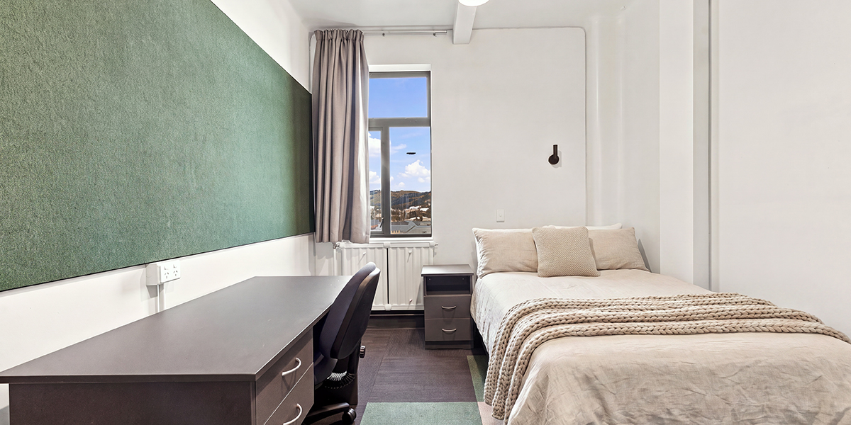 Student bedroom with bed and desk