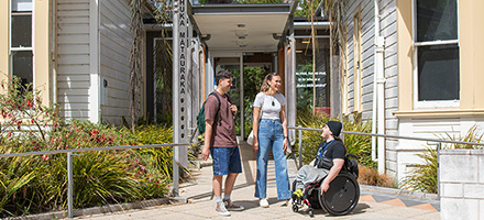 Three students outside the entrance to the Māori Centre image 1x