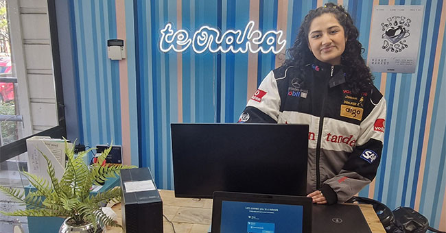 ITS Infrastructure Intern Shreya Das with some of the IT equipment available for purchase by students and staff at Te Oraka.