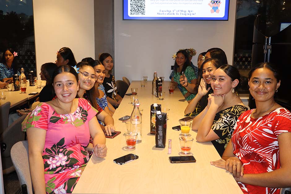 A group of female Pacific Island students sitting at a table in colourful clothing