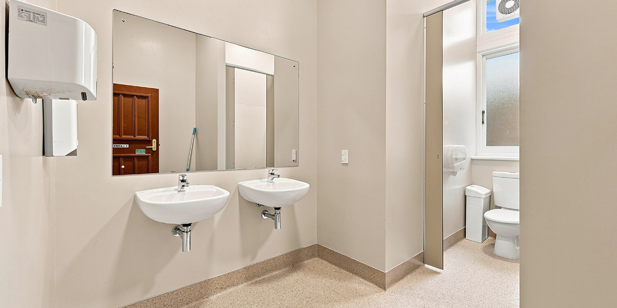 Bathroom with toilet and sinks