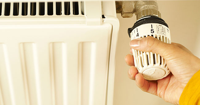 Hand on thermostat thumbnail image