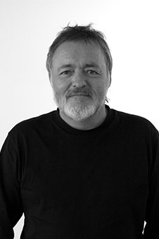 A black and white headshot of a man.