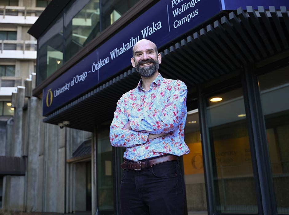 A photo of Professor William-Levack in front of the Wellington campus entrance