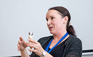 Dr Gabriella Lindberg holding a hip implant thumbnail