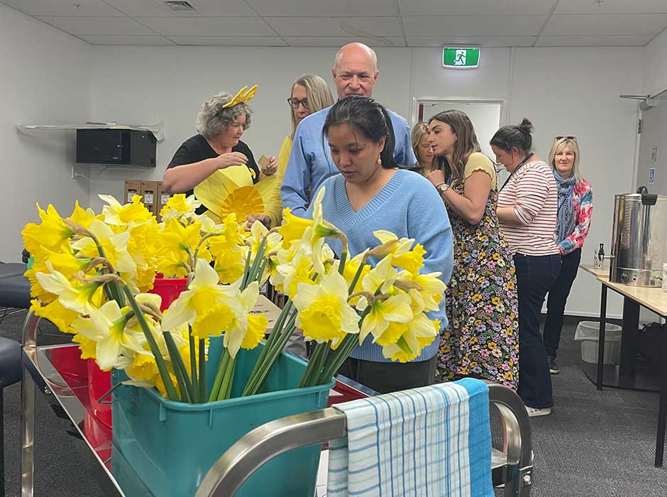 People around a bucket of daffodils 