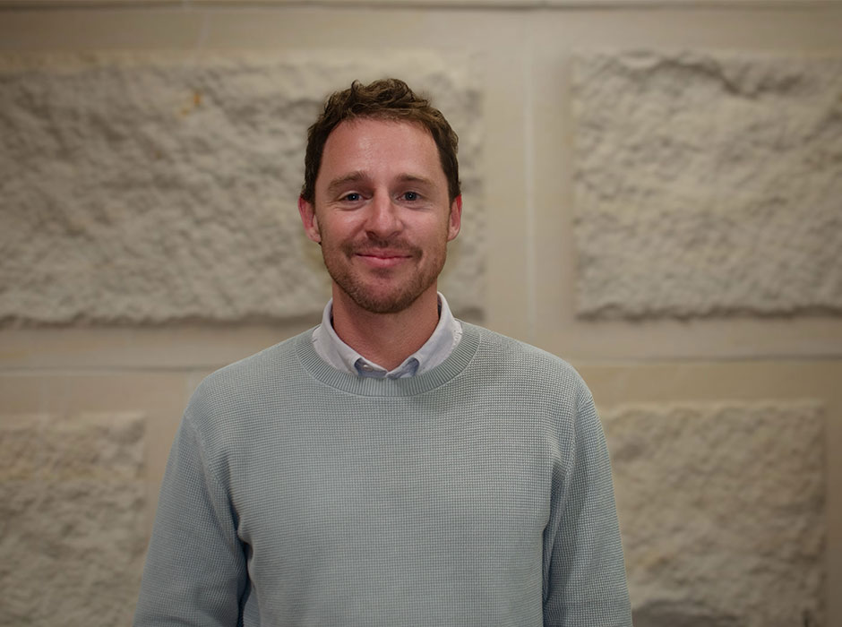 A man standing in front of a wall 