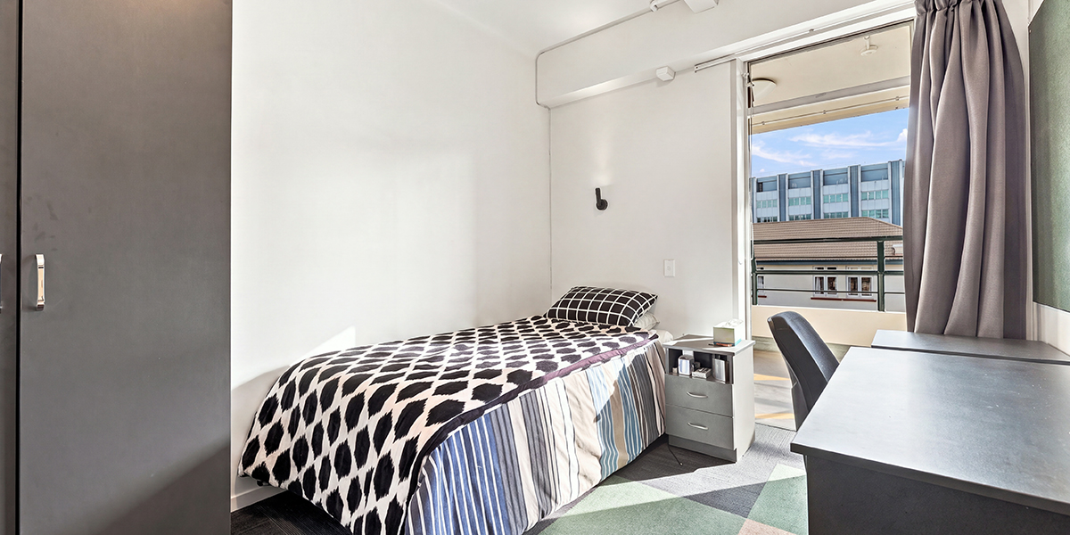 Bedroom with bed, desk and window