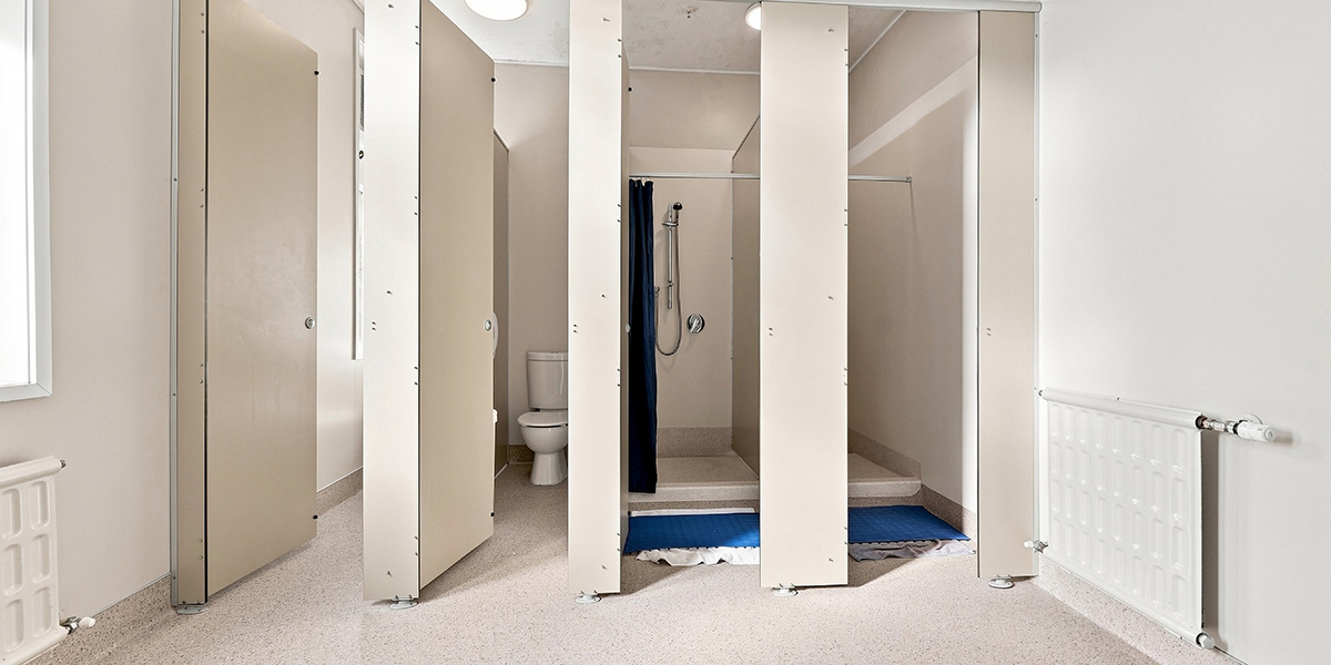Shared bathroom facilities with shower and toilet cubicles