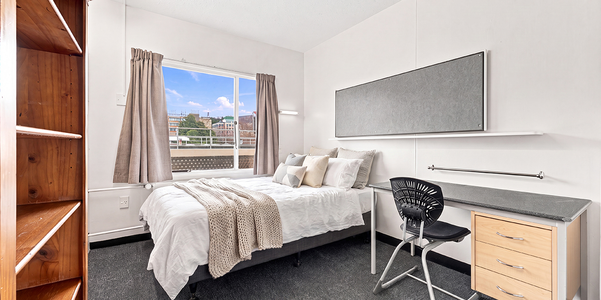 Student bedroom with desk and shelves