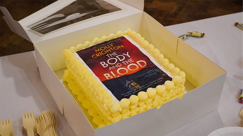 A cake decorated with the cover of the book.