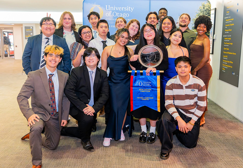 Group of Intercollege Competition students holding competition champion ribbon and trophy.