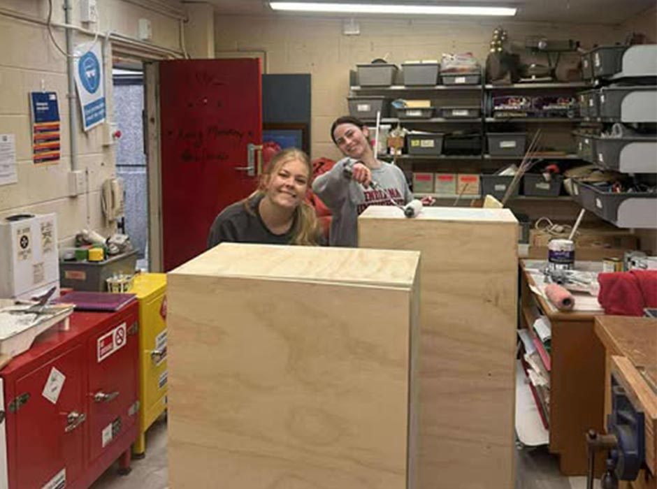 Working on drop-off cabinets for The Bowling club are, from left, Alyssa Fisher and Sophie Wells. 
