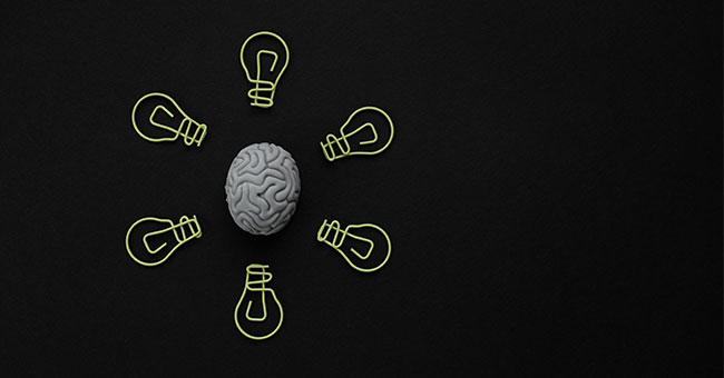 a cartoon brain with lightbulbs around it
