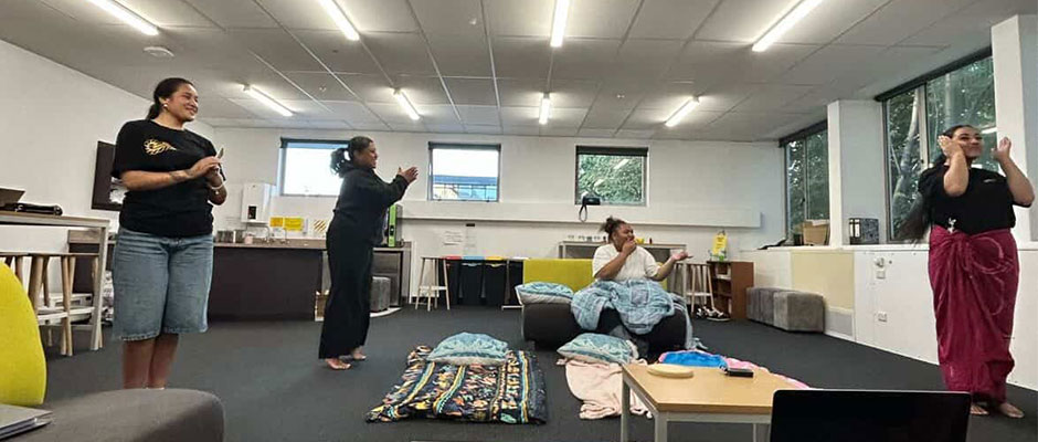 Four young women rehearse in an office space.